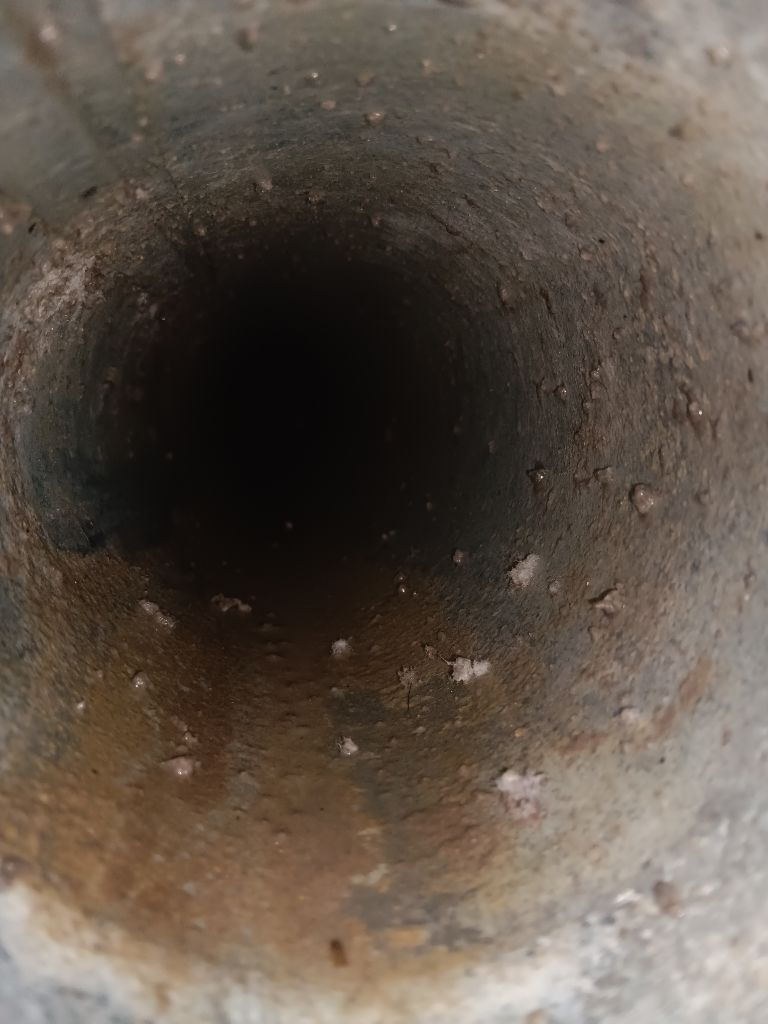 A close up of the inside of a concrete pipe.