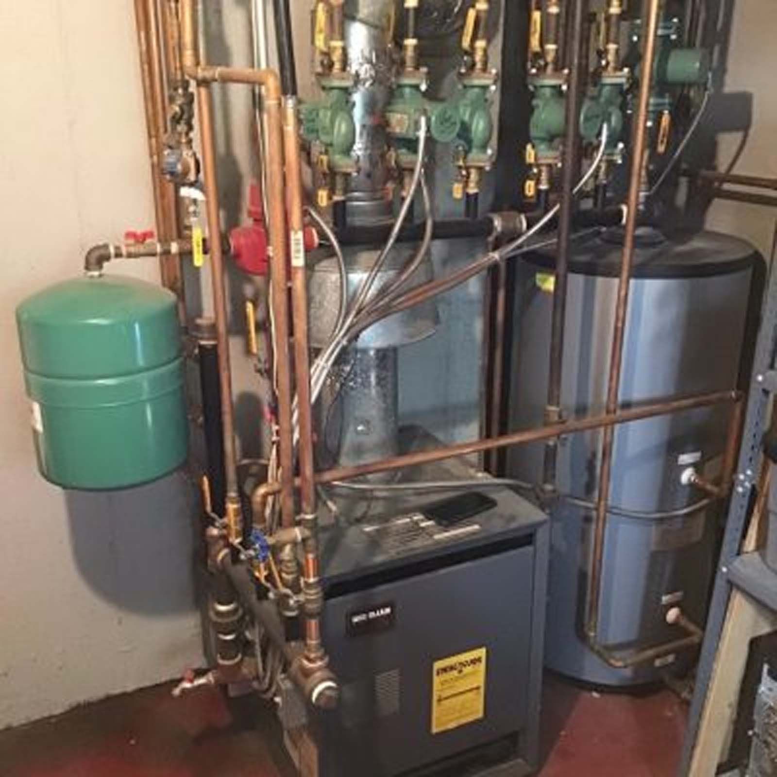 A water heater with a yellow sticker on it