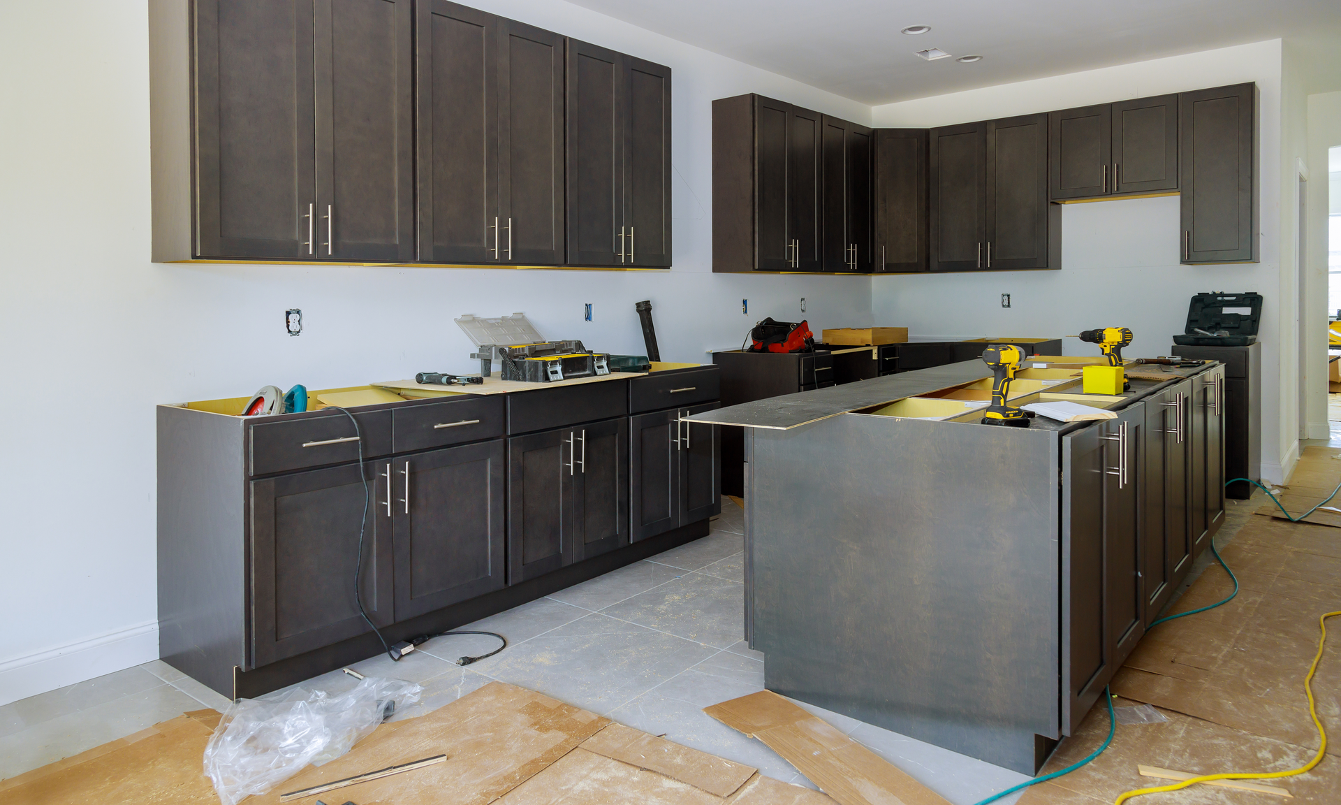 a photo of a kitchen that just recently had new cabinets installed. it is still missing countertops and appliances.