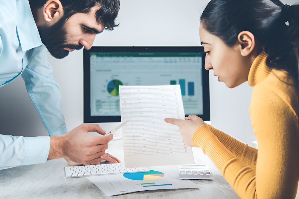 A Man And A Woman Are Looking At Money Computation — Christies Accountants & Advisors In Dubbo, NSW
