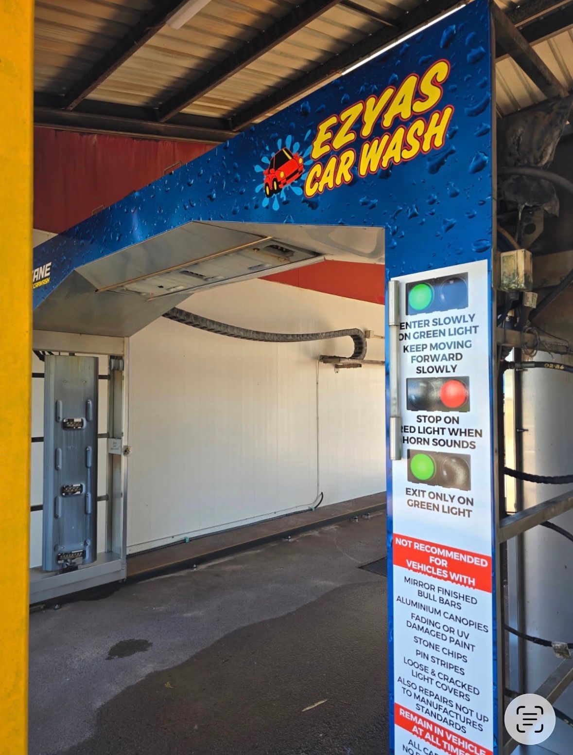 Ezyas Car Wash entrance with overhead sign and illuminated control panel under a covered bay — Ezyas Car Wash NT in Yarrawonga, NT