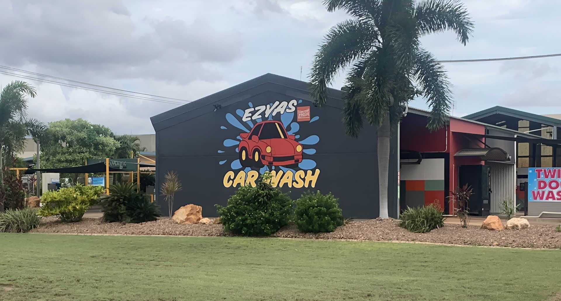 Exterior of EZ YAS Car Wash; a red car graphic on a gray building. — Ezyas Car Wash NT in Yarrawonga, NT