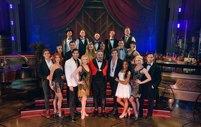 A group of people are posing for a picture on a stage.