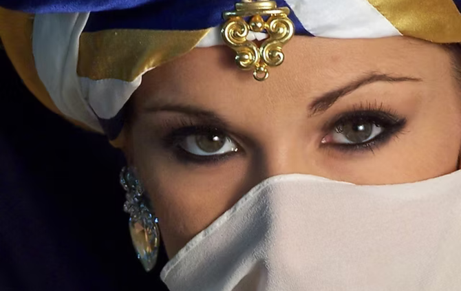 A woman wearing a turban and a veil covering her face