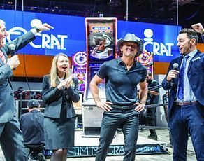 A man in a cowboy hat is standing in front of a group of people.