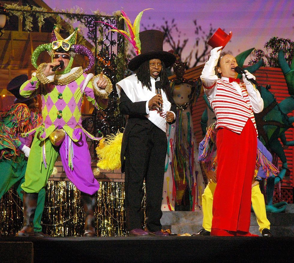 A man in a top hat is singing into a microphone