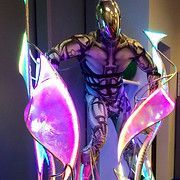 Futuristic figure in silver armor, with glowing pink and blue accents.