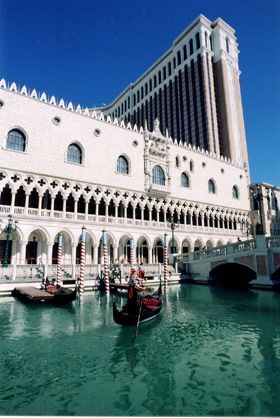 Gondolas float on turquoise water beneath the Venetian hotel in Las Vegas.