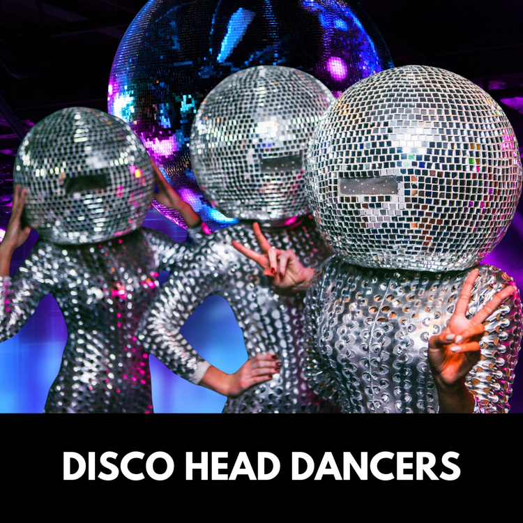 Three people wearing disco ball heads and silver jumpsuits, posing in front of a mirrored ball.