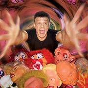 Man with outstretched arms surrounded by clown and face masks in a swirling, colorful background.