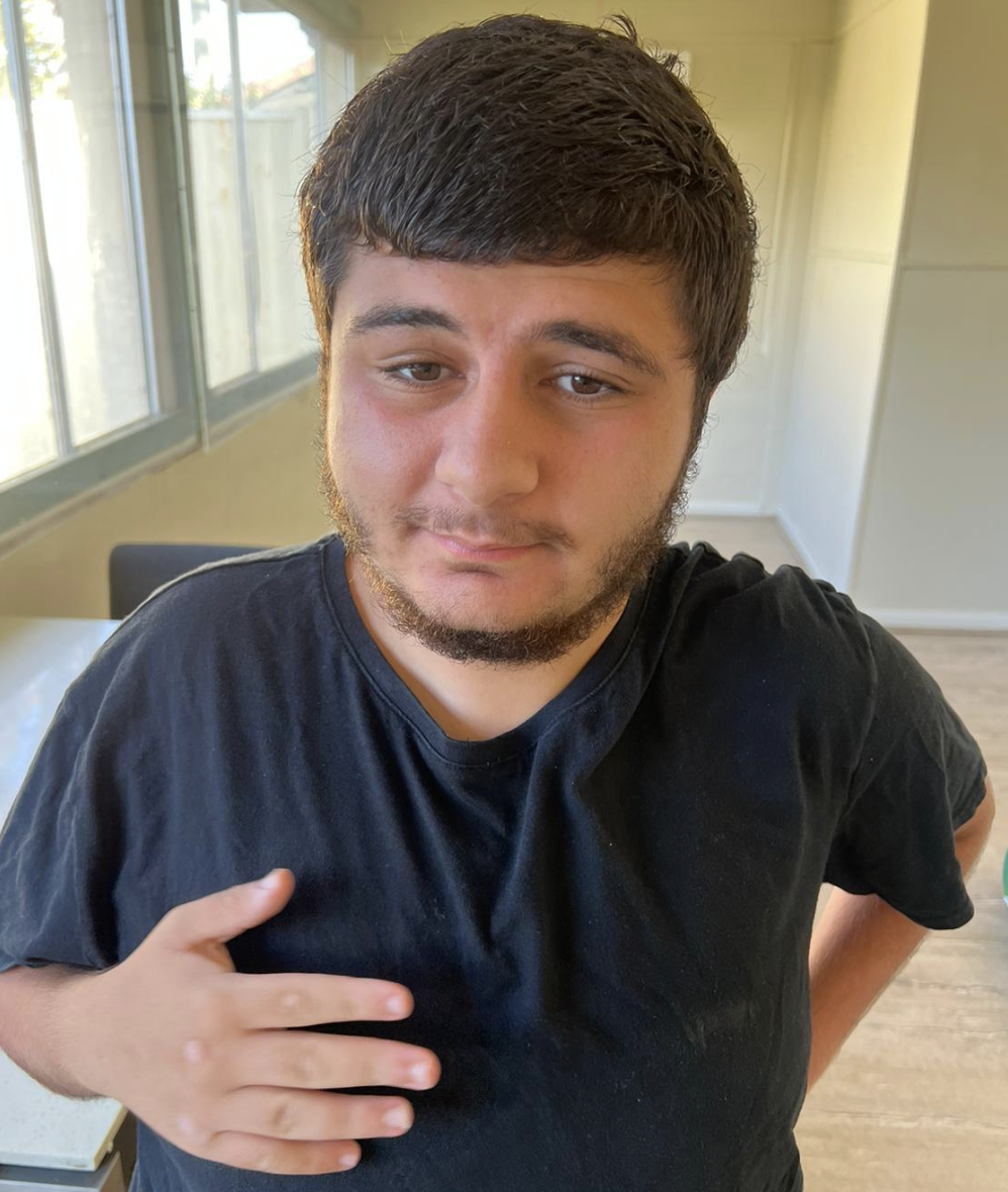 A woman in a blue jacket is sitting in a wheelchair