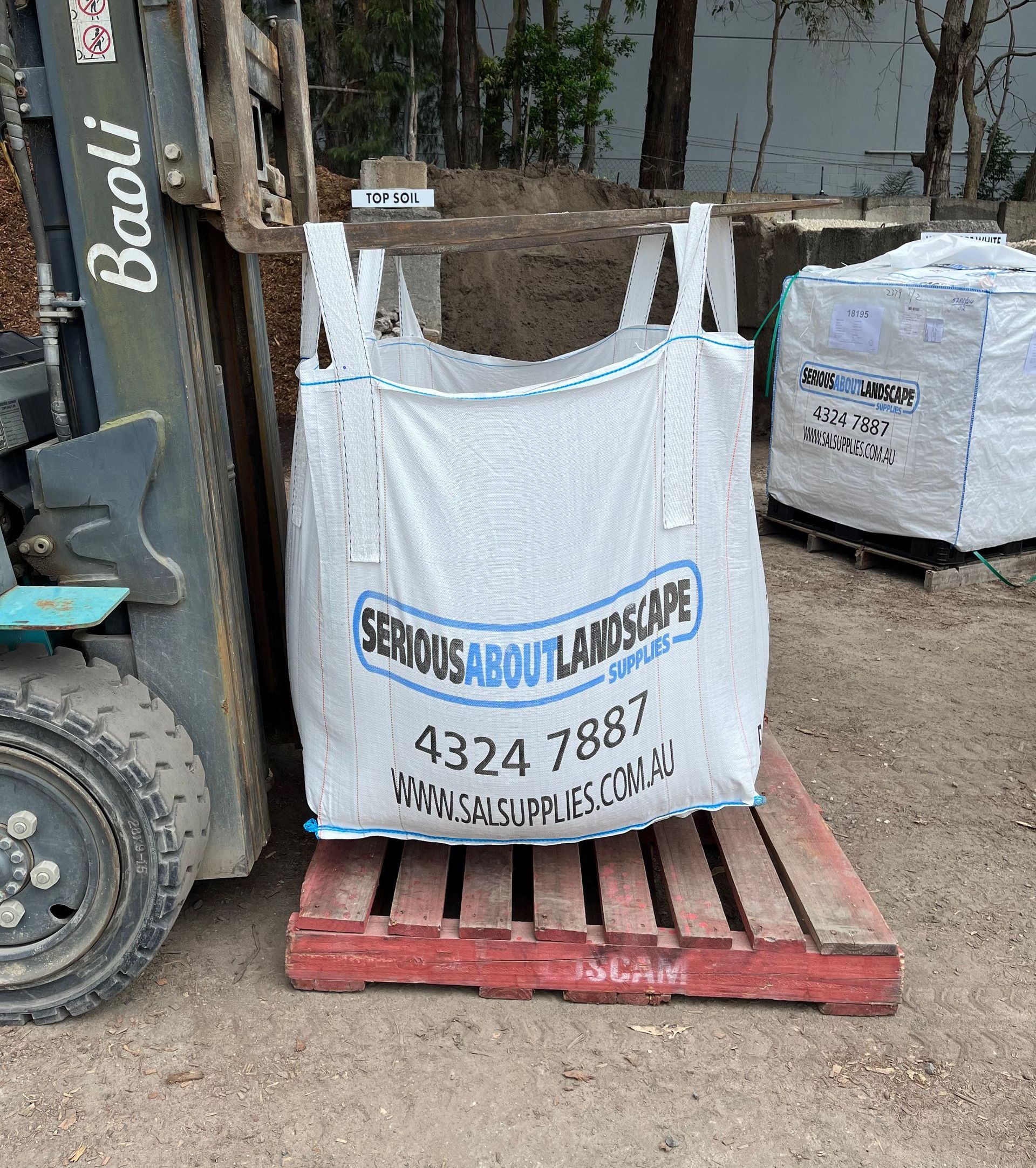A Bunch Of Bags Are Stacked On Top Of Each Other On A Dirt Field — Serious About Landscape Supplies In West Gosford, NSW