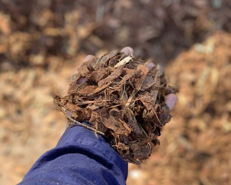 A Pile Of Wood Chips Is Sitting On The Ground — Serious About Landscape Supplies In West Gosford, NSW