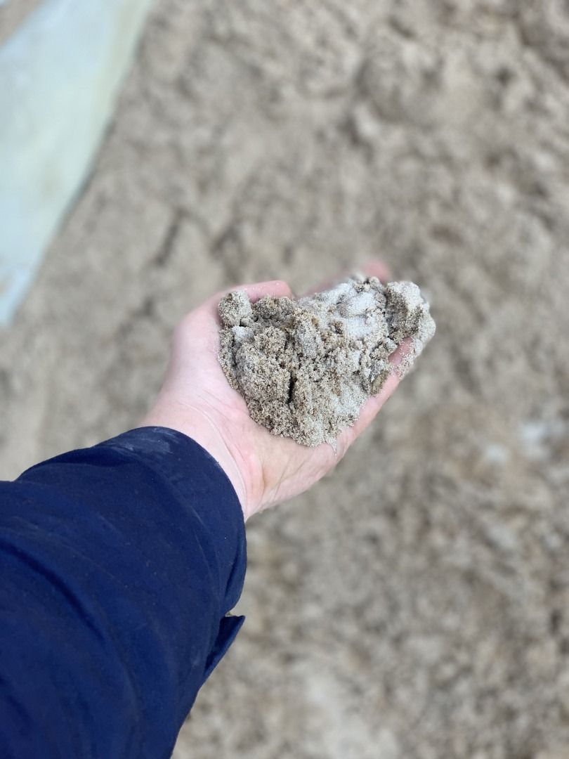 A Person Is Holding A Pile Of Sand — Serious About Landscape Supplies In West Gosford, NSW