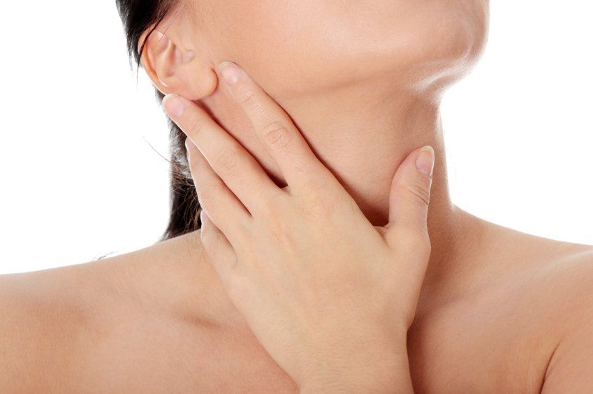 Image of a woman using her hand to soother her throat
