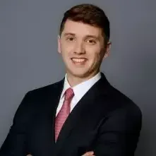 A man in a suit and tie is smiling for the camera.