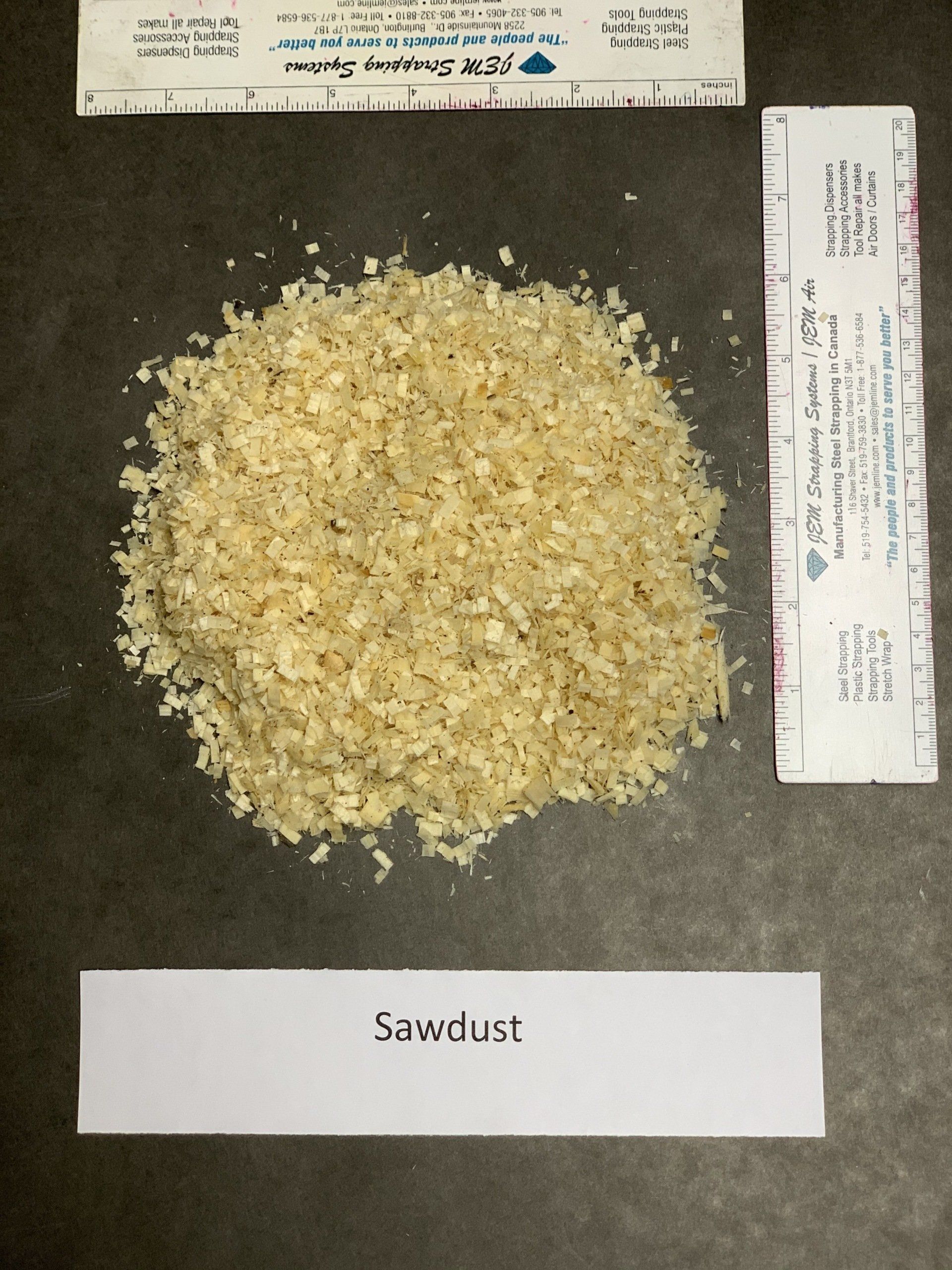 small beige wood shavings on black background