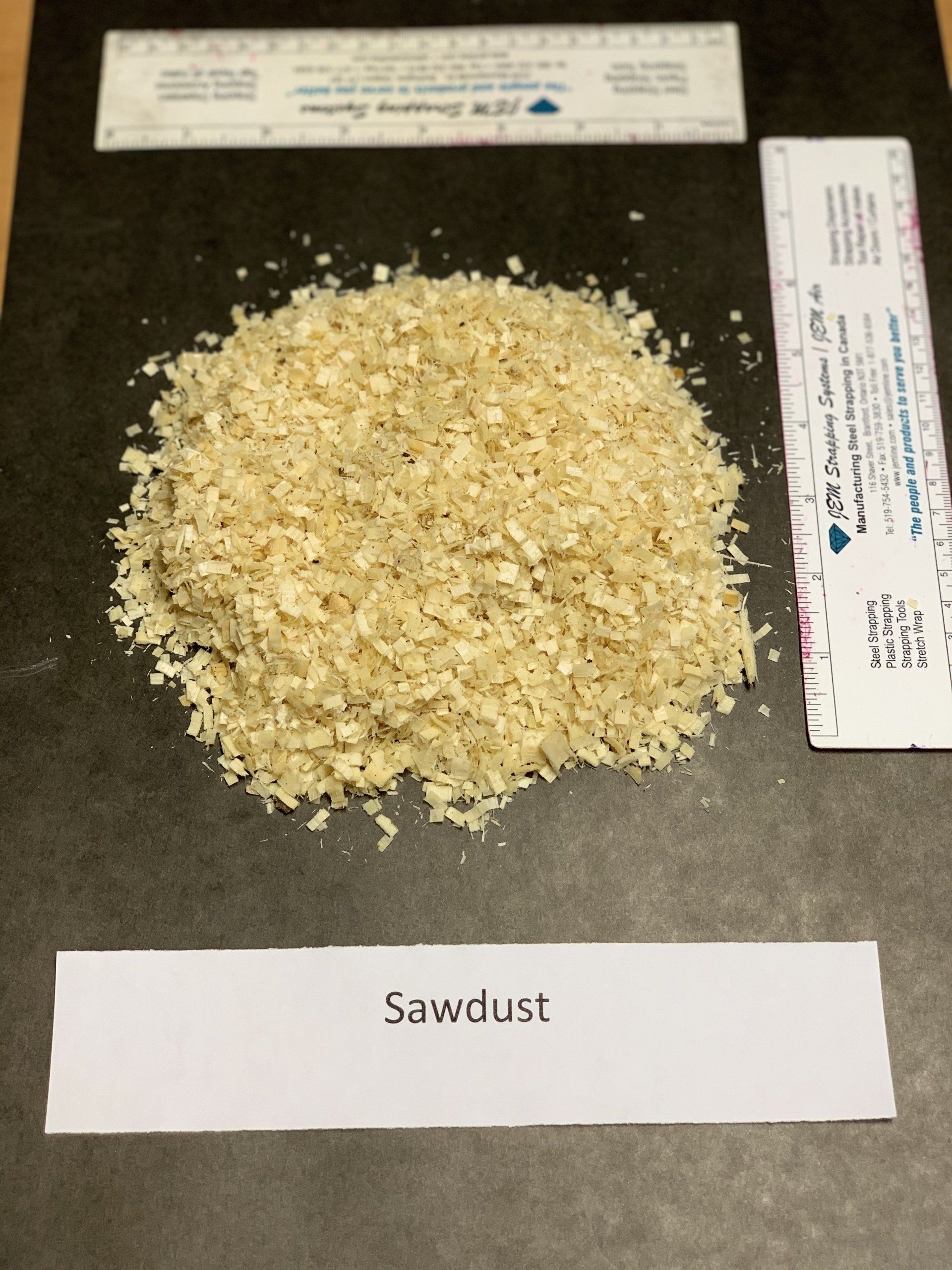 small beige wood chips on black background