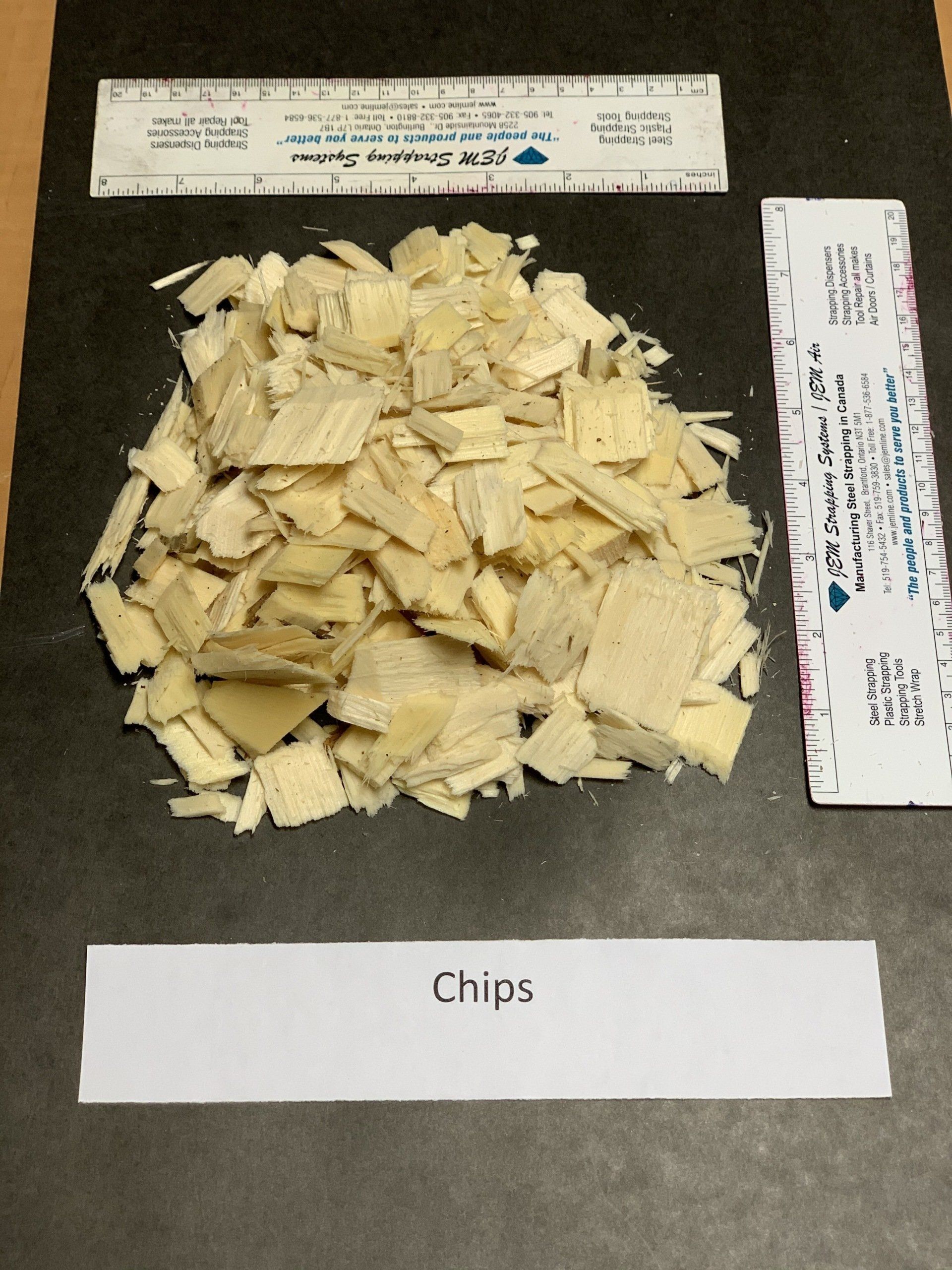 small beige wood chips on black background