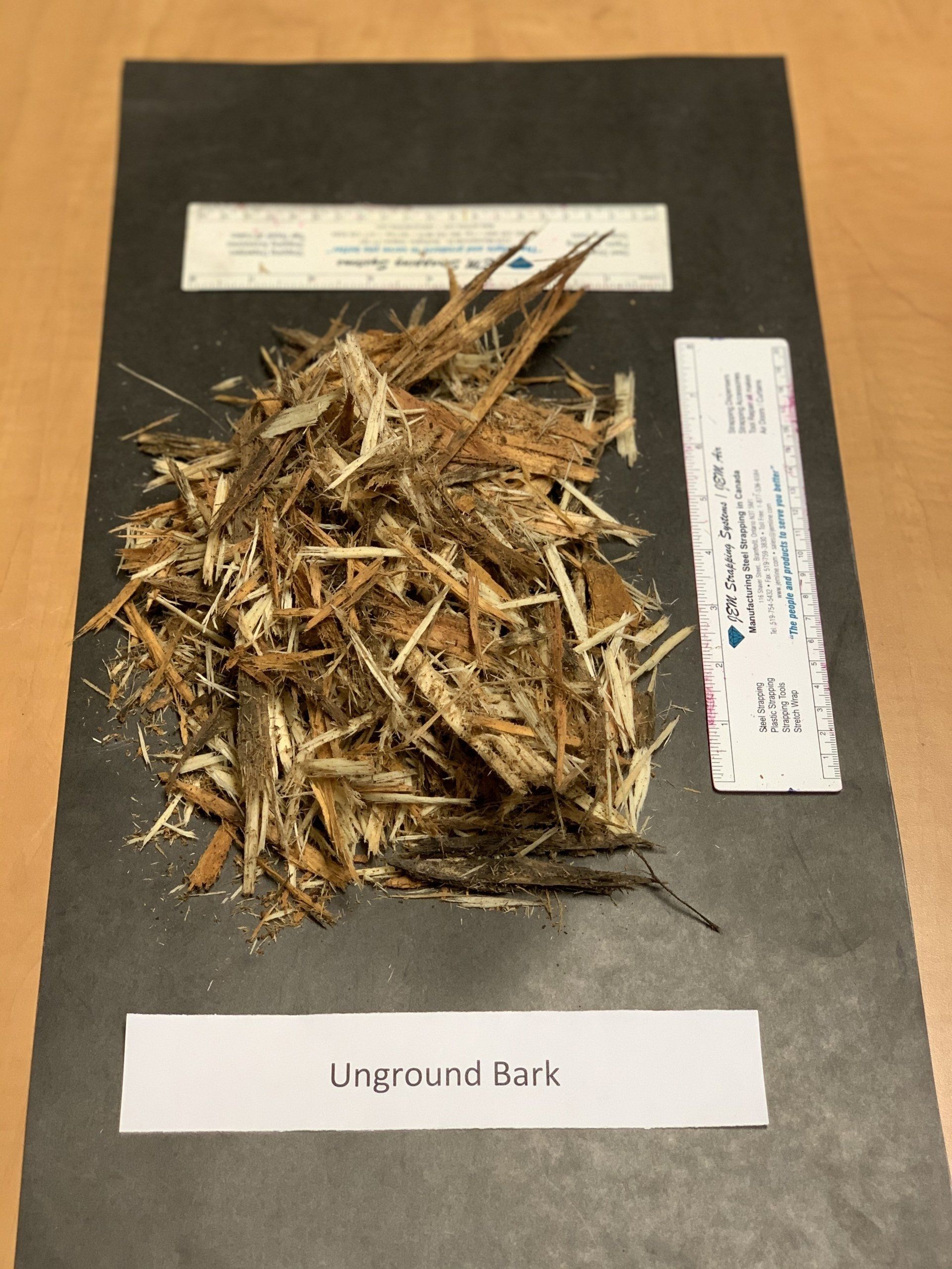 large brown wood shavings on black background