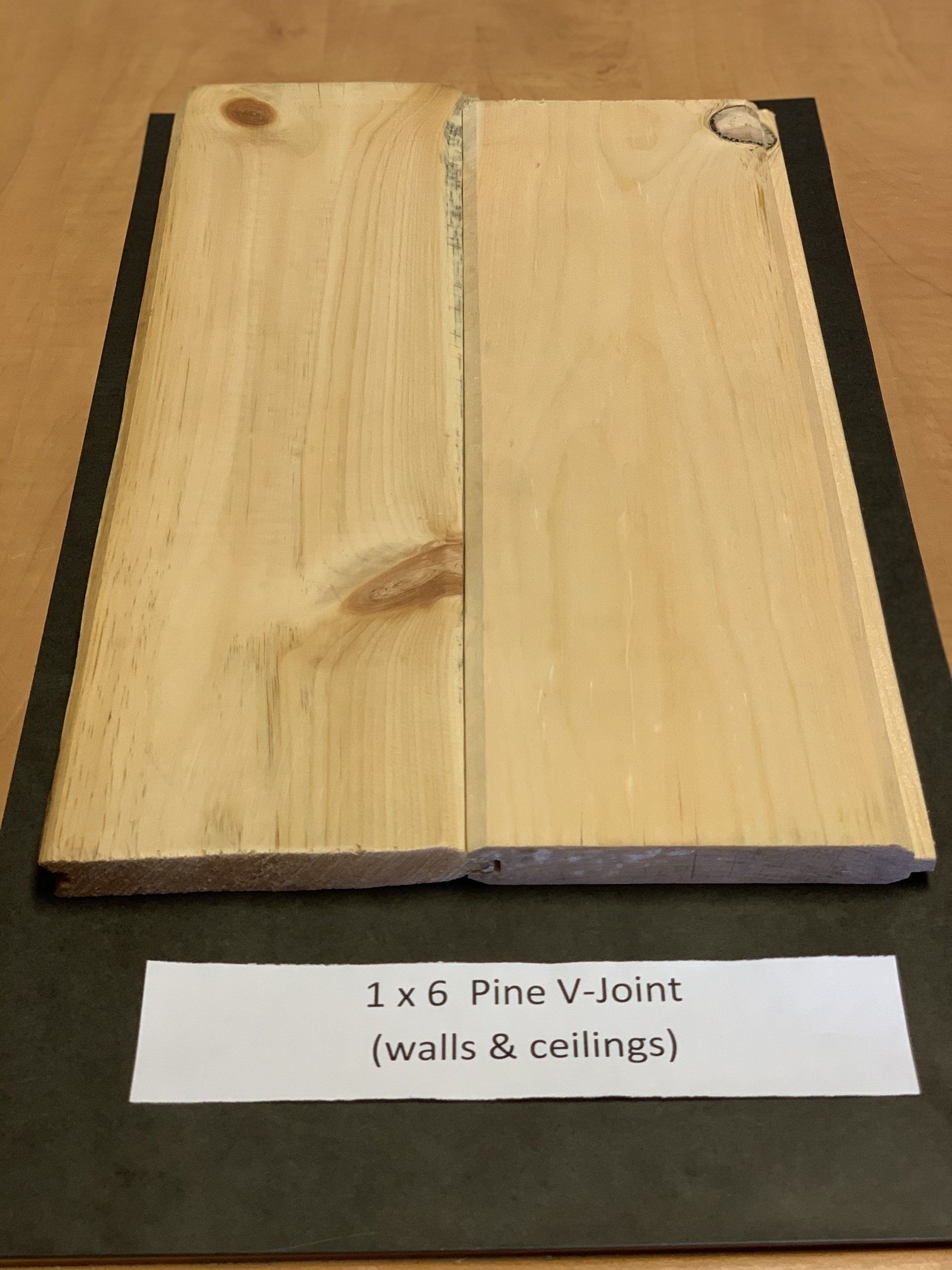 close up of long beige pine wood siding slabs