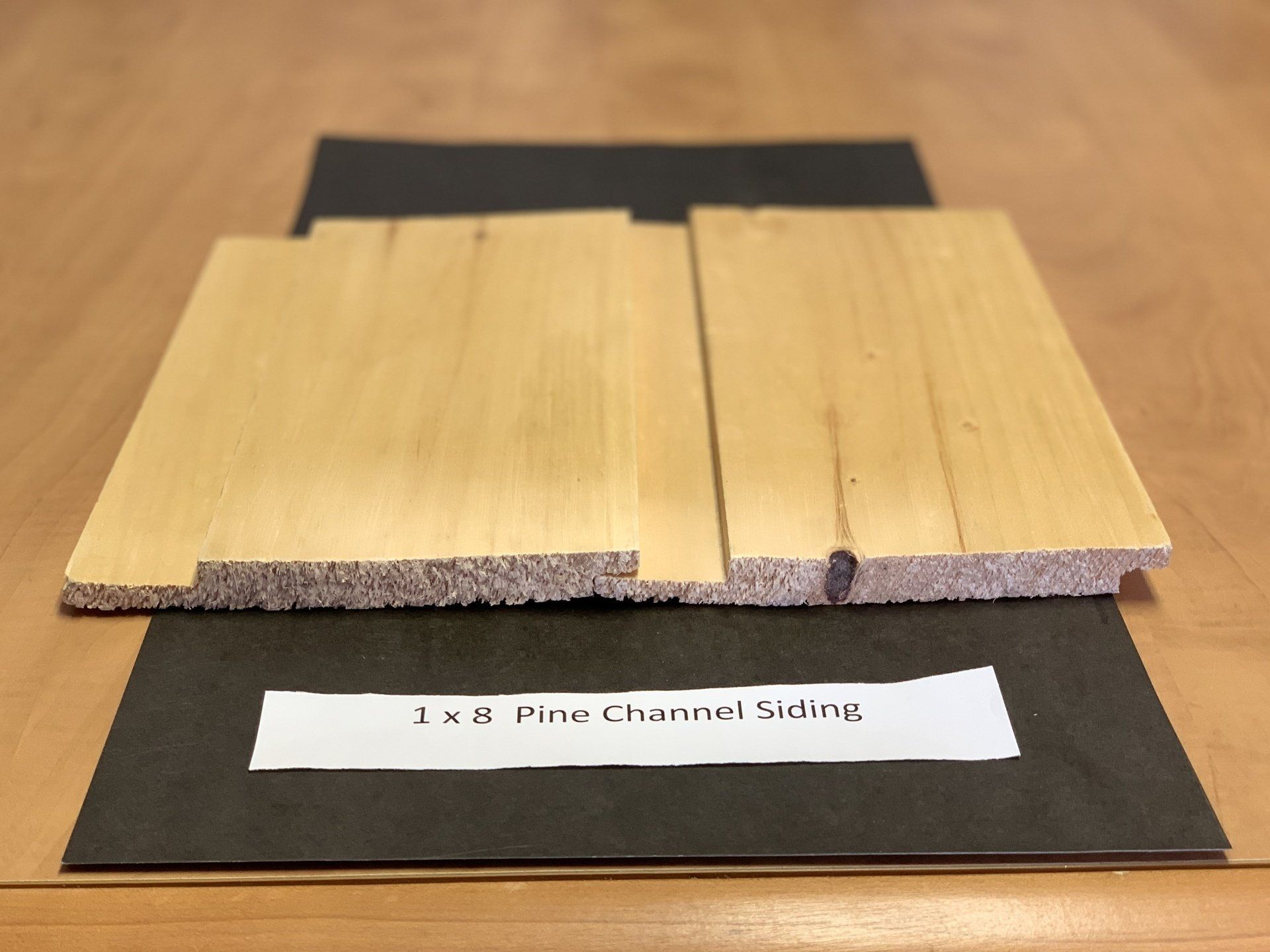 close up of beige pine wood siding slabs