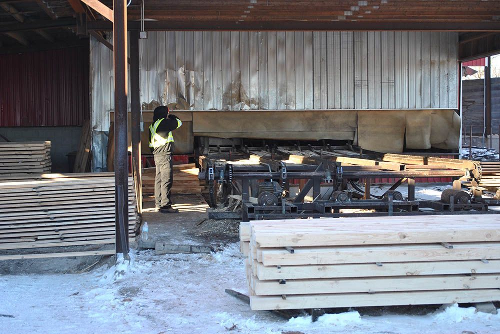 piles of wood planks in lumberyard