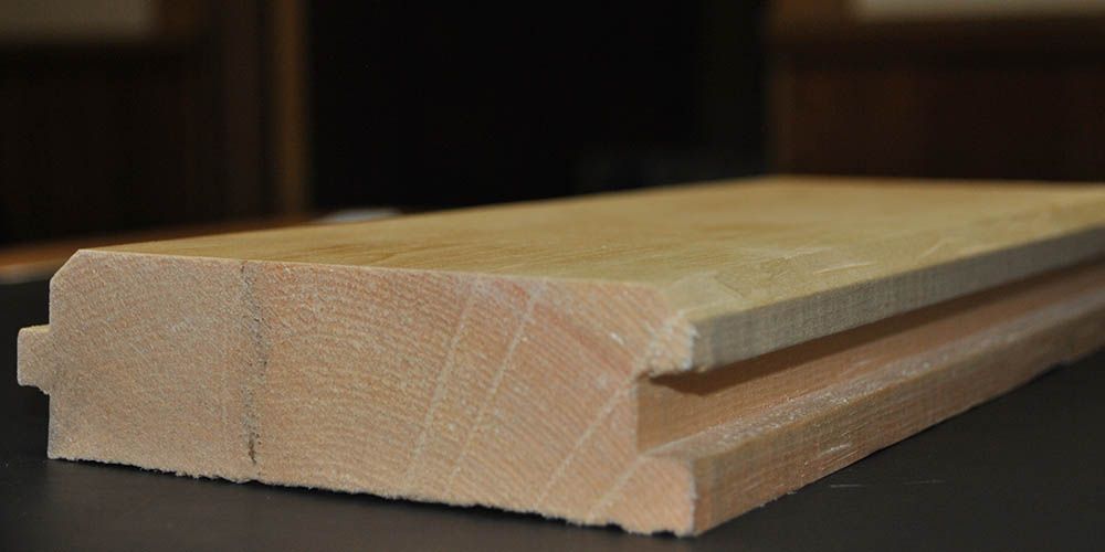 large plank of beige pine wood with groove