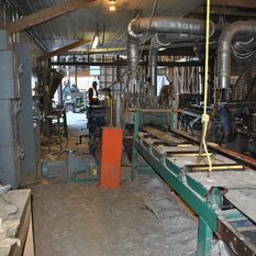 warehouse filled with heavy machinery for wood treatment