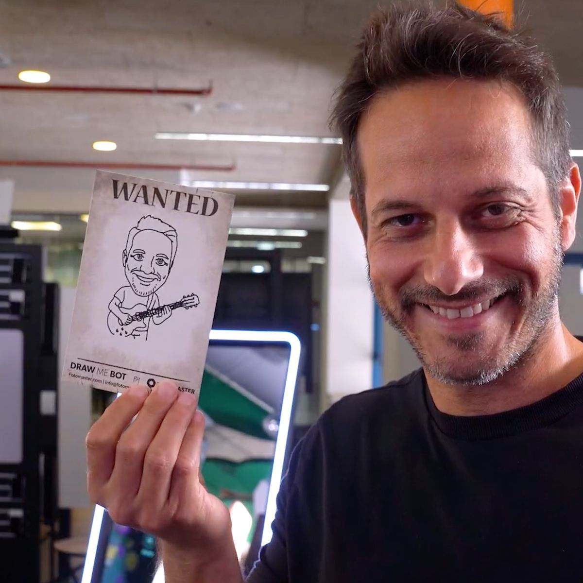 A smiling person holds up a