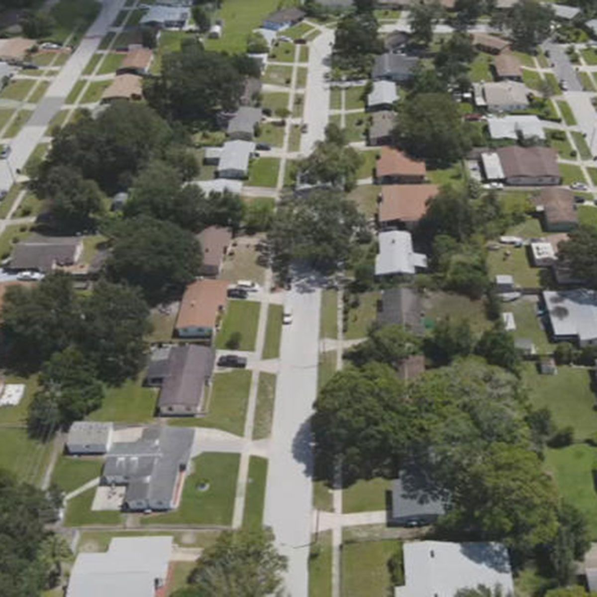 An aerial view of a residential area with lots of houses and trees