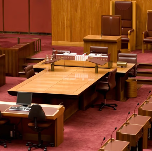 a conference room with a large wooden table and chairs