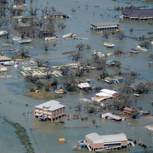 an aerial view of a flooded area with houses and trees