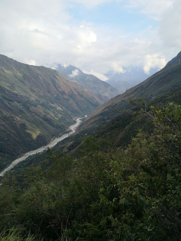 A river runs through a valley between two mountains.