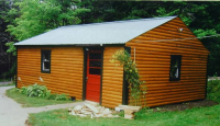 After: a shed with new log siding
