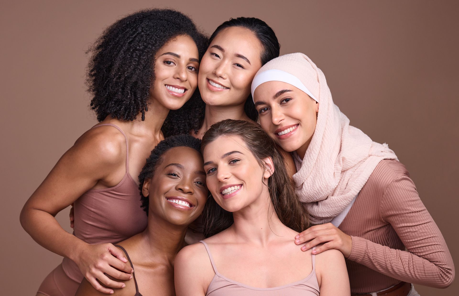 A group of women of different races are posing for a picture together.