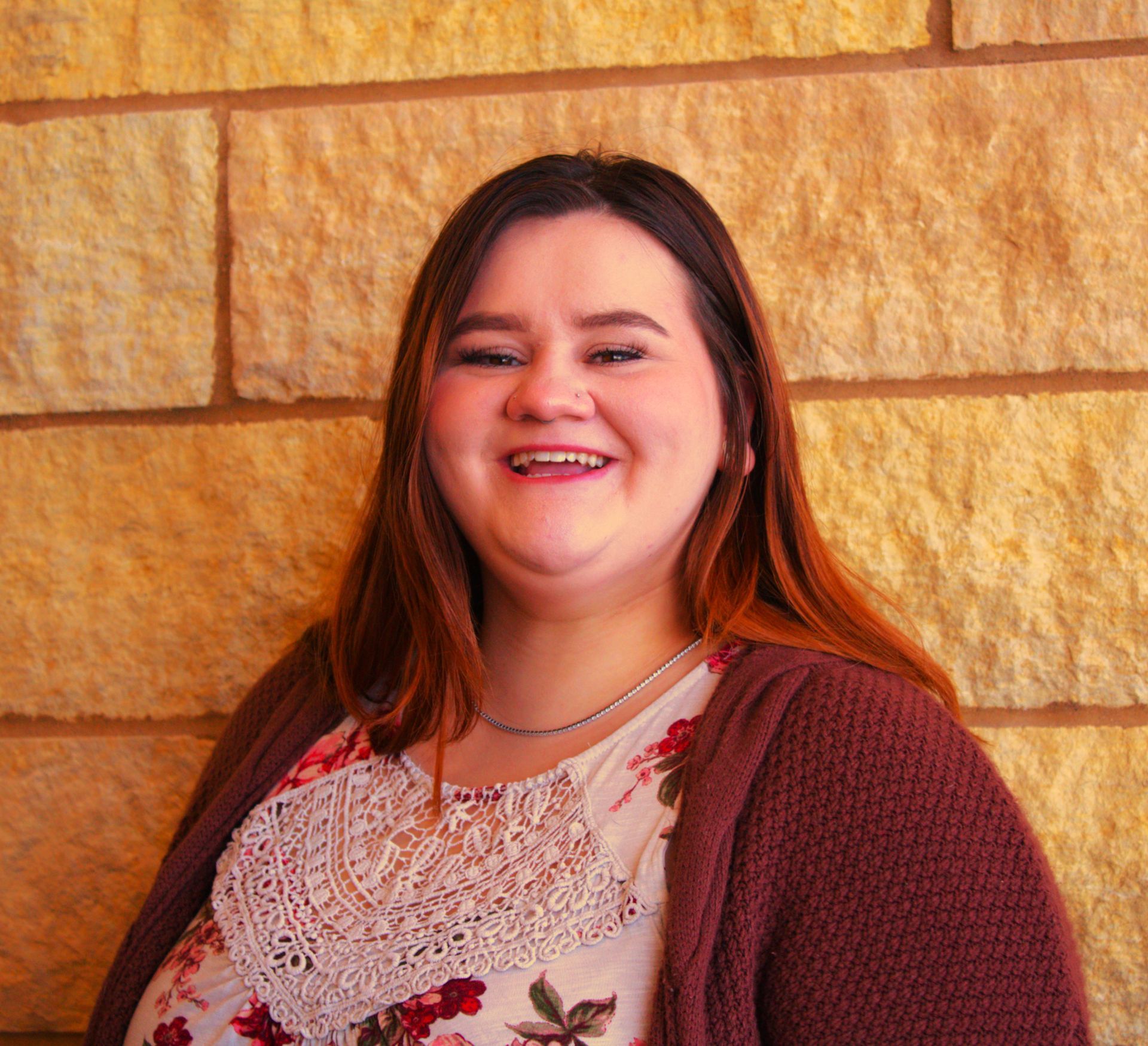 An addiction education counselor with a beard is wearing a plaid shirt and a vest.