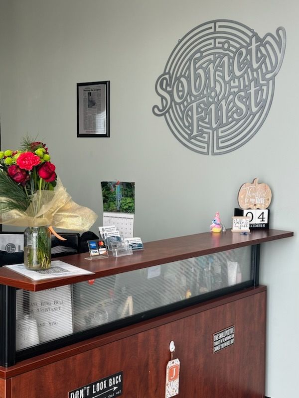 Drug treatment center reception desk with a sign on the wall that says southern first