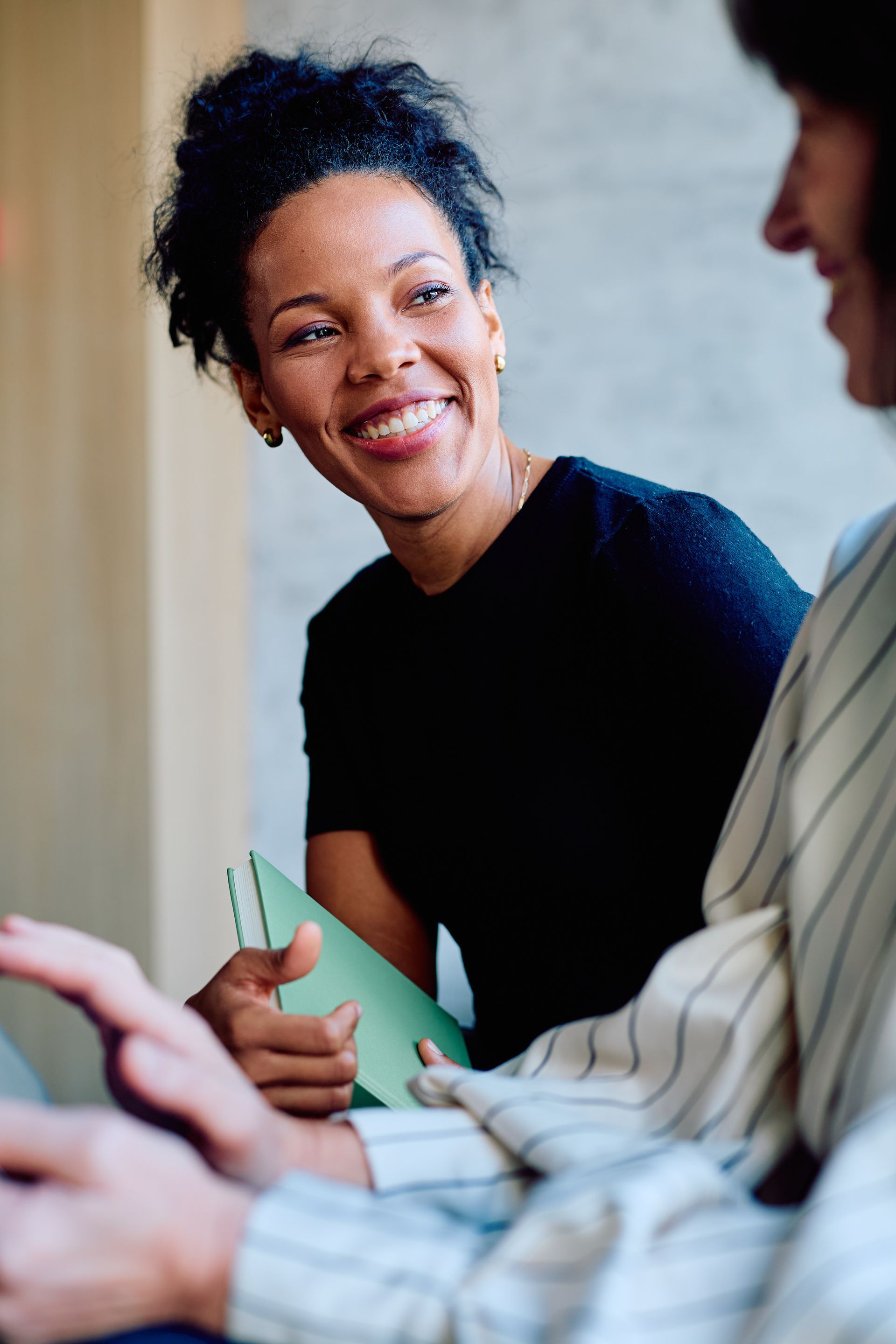 Individual participating in a supportive recovery discussion at an AA meeting.