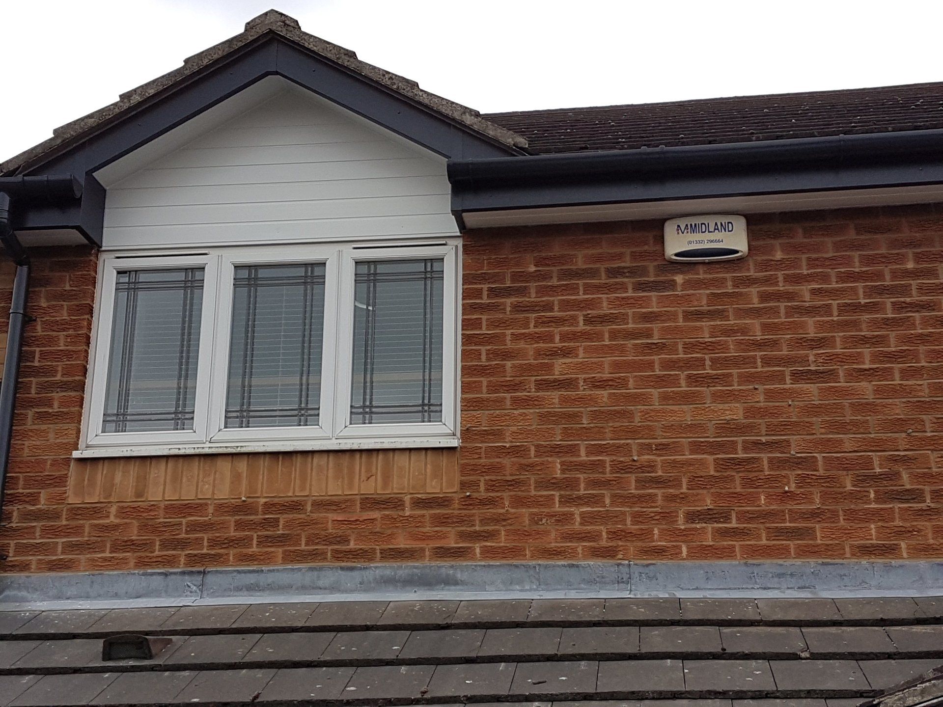 Apex-Grey UPVC fascia, white soffits and grey guttering in Coalville