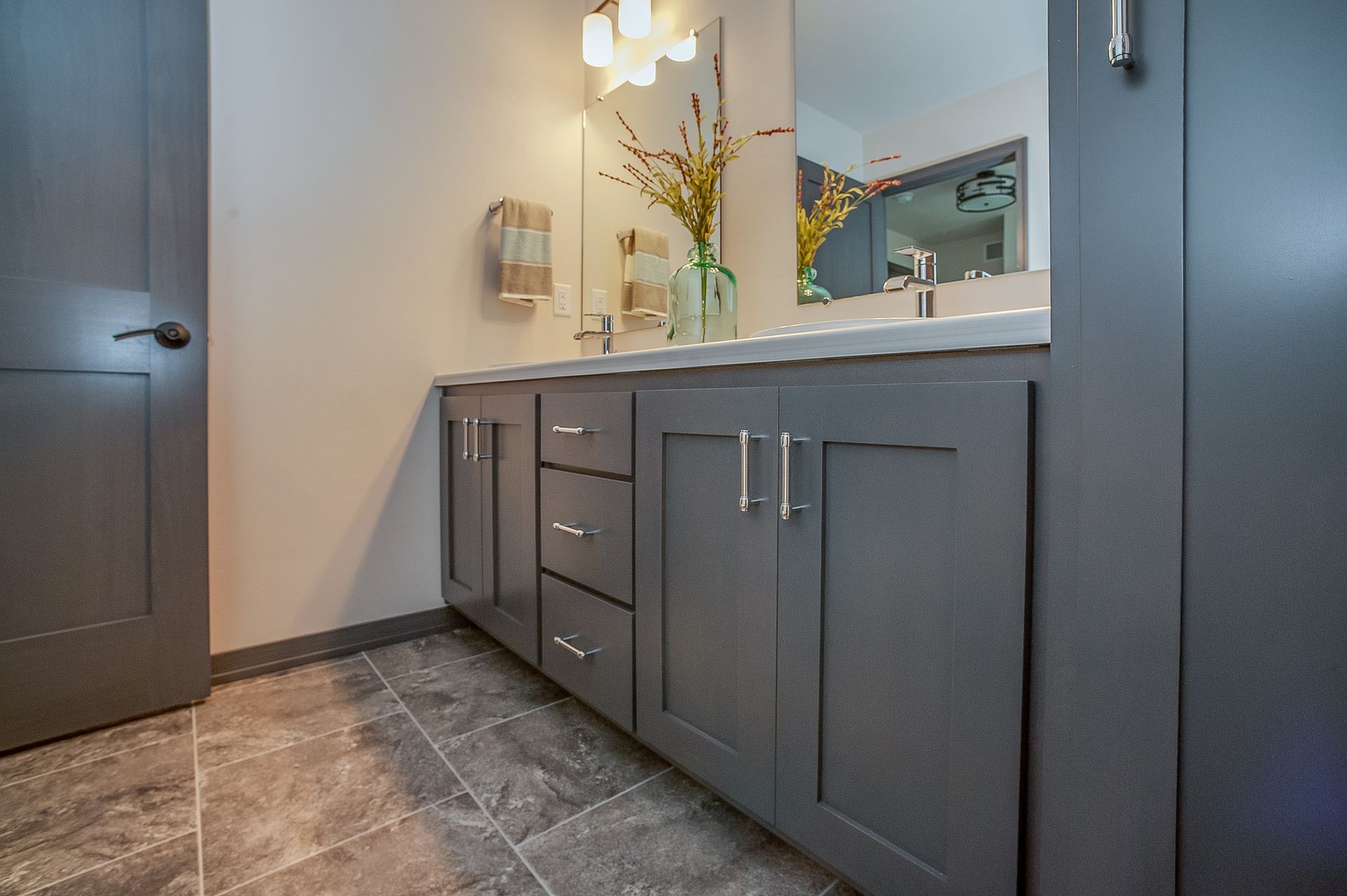 A bathroom with two sinks and a mirror.