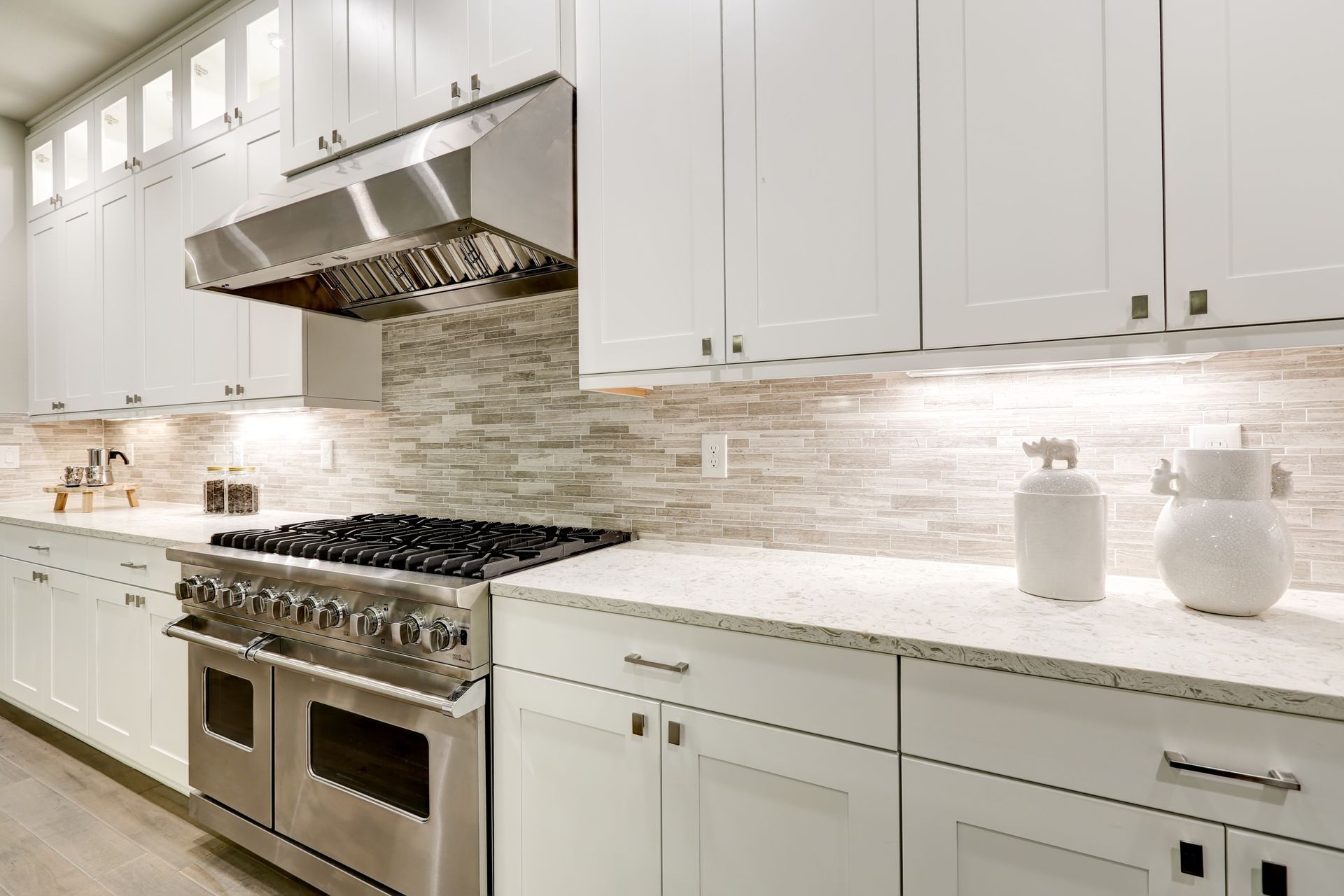 A kitchen with white cabinets and stainless steel appliances.