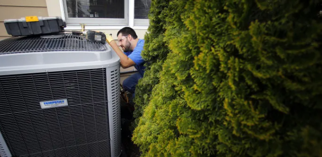 A service man doing check up for the AC | Springfield, OH | Delong Air Inc.