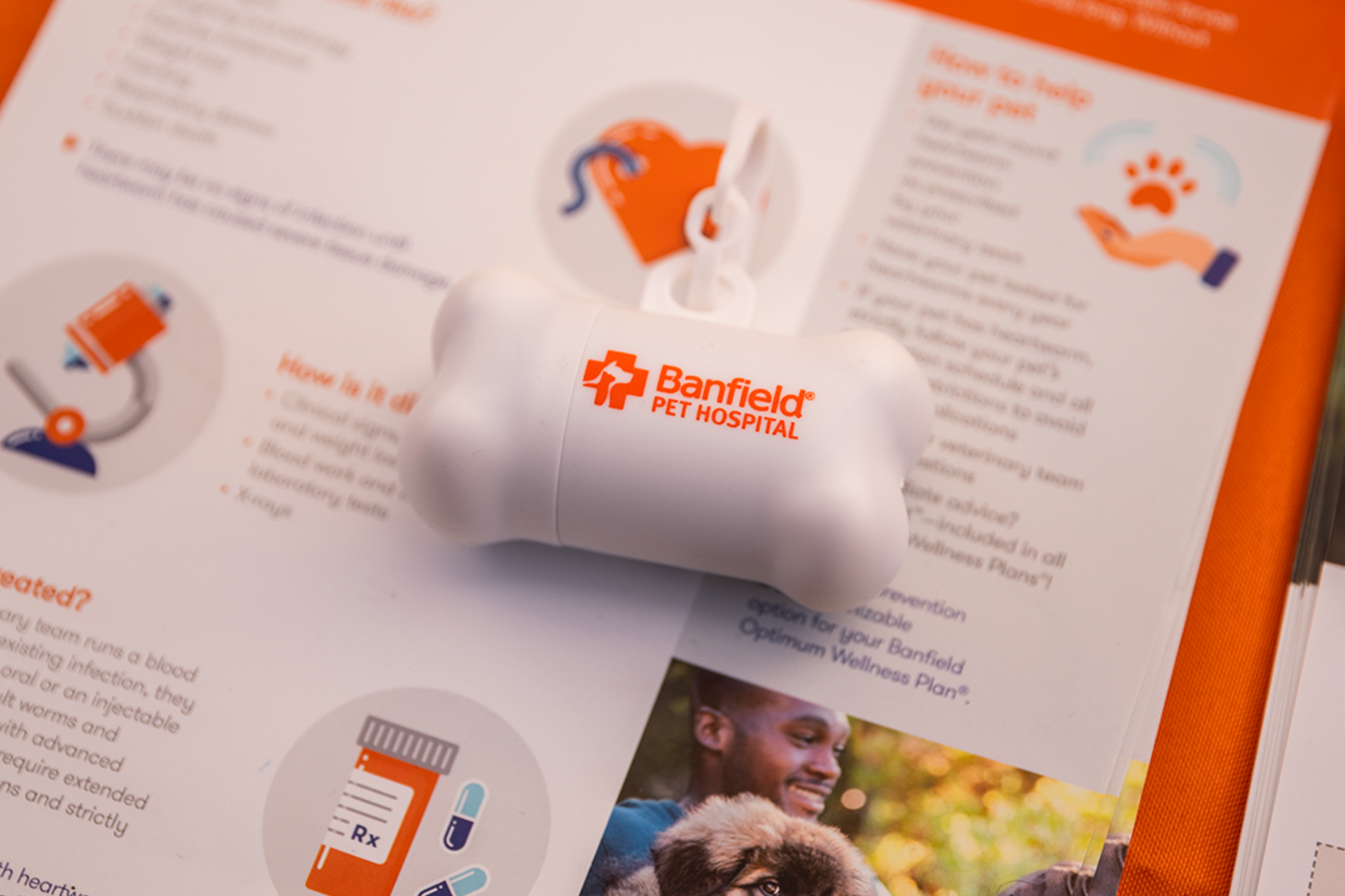 Health brochure with orange accents, a pill bottle, and a family photo on a table