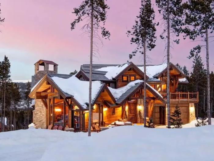 A small Victorian brick house with a white picket fence in Aspen CO