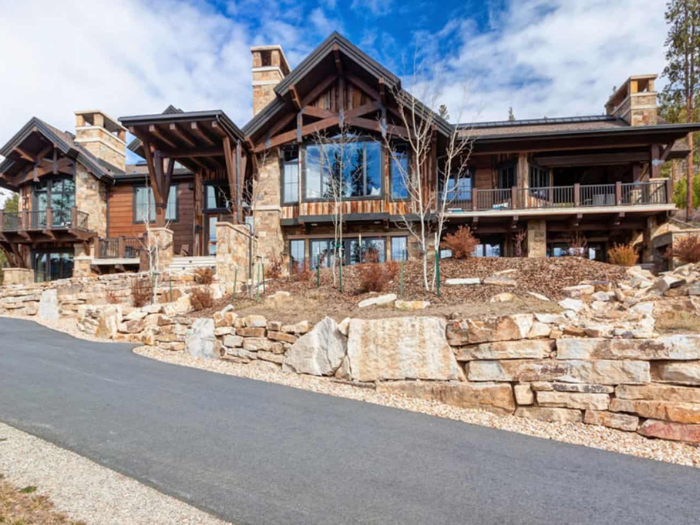 A large house in the Aspen snow with mountains in the background