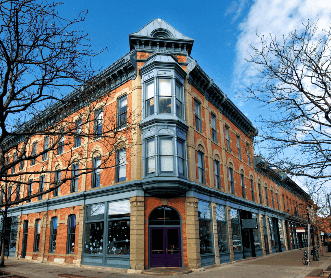 A large brick building with a purple door on the corner