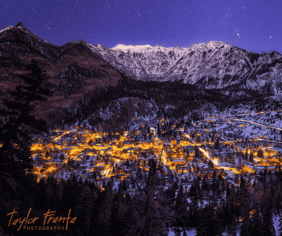 A photograph of a mountain town at night by taylor frente