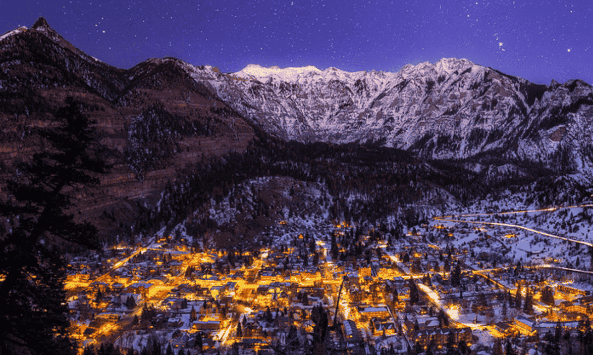 A photograph of a mountain town at night by taylor frente
