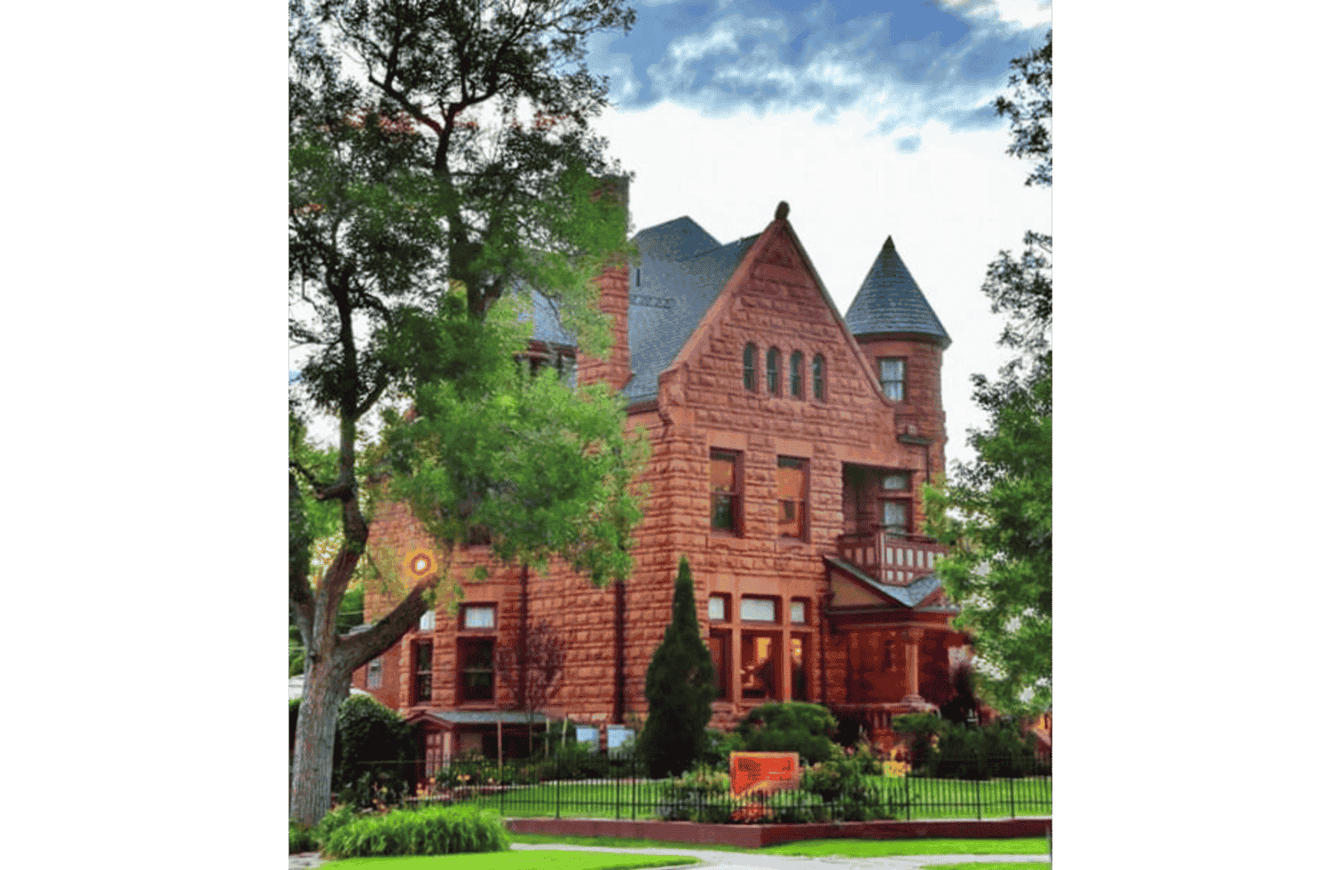 A large red brick building with trees in front of it